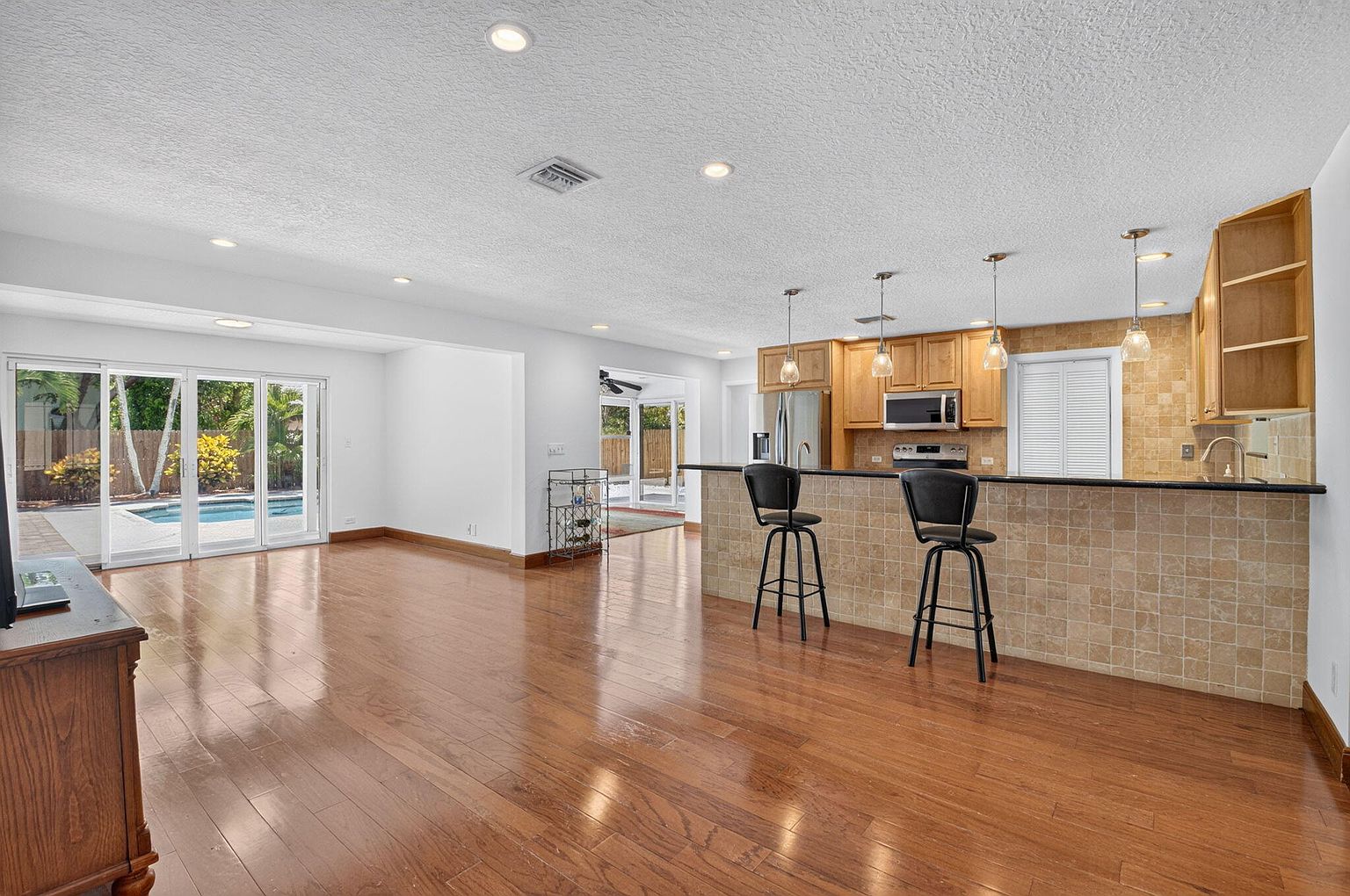 Great room opening to the kitchen and pool, 1170 SW 21st Street, Boca Raton FL